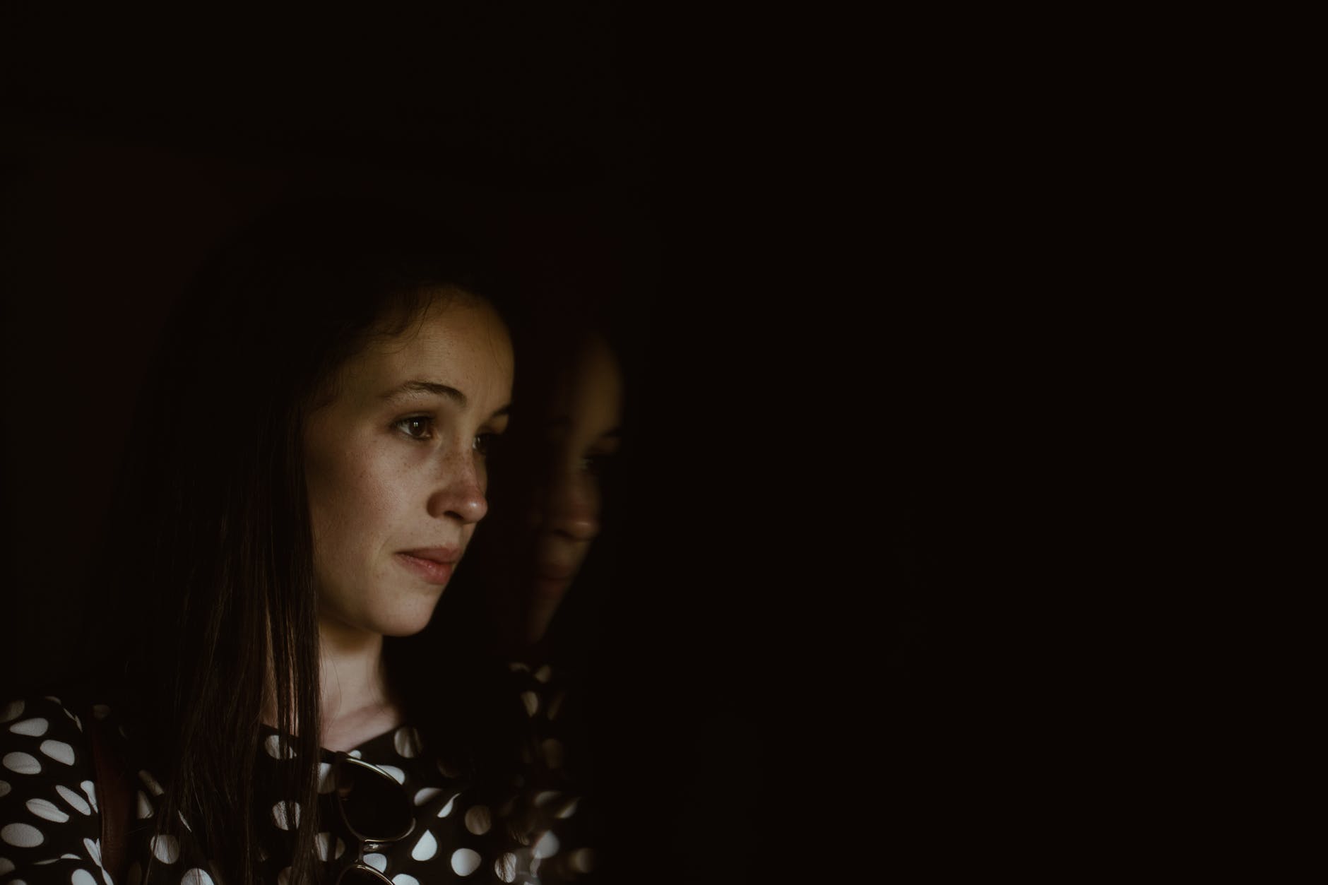 woman wearing black and white polka dot shirt