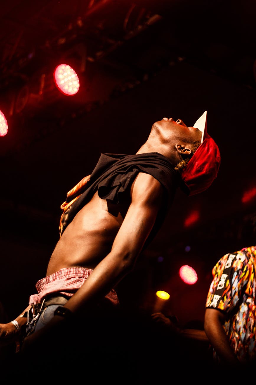 topless man wearing red flat brim cap