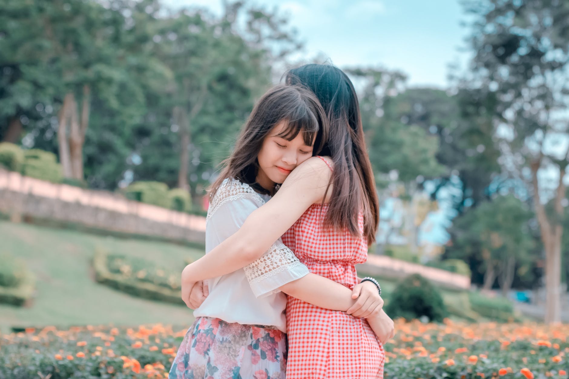 candid photography of two female hugging